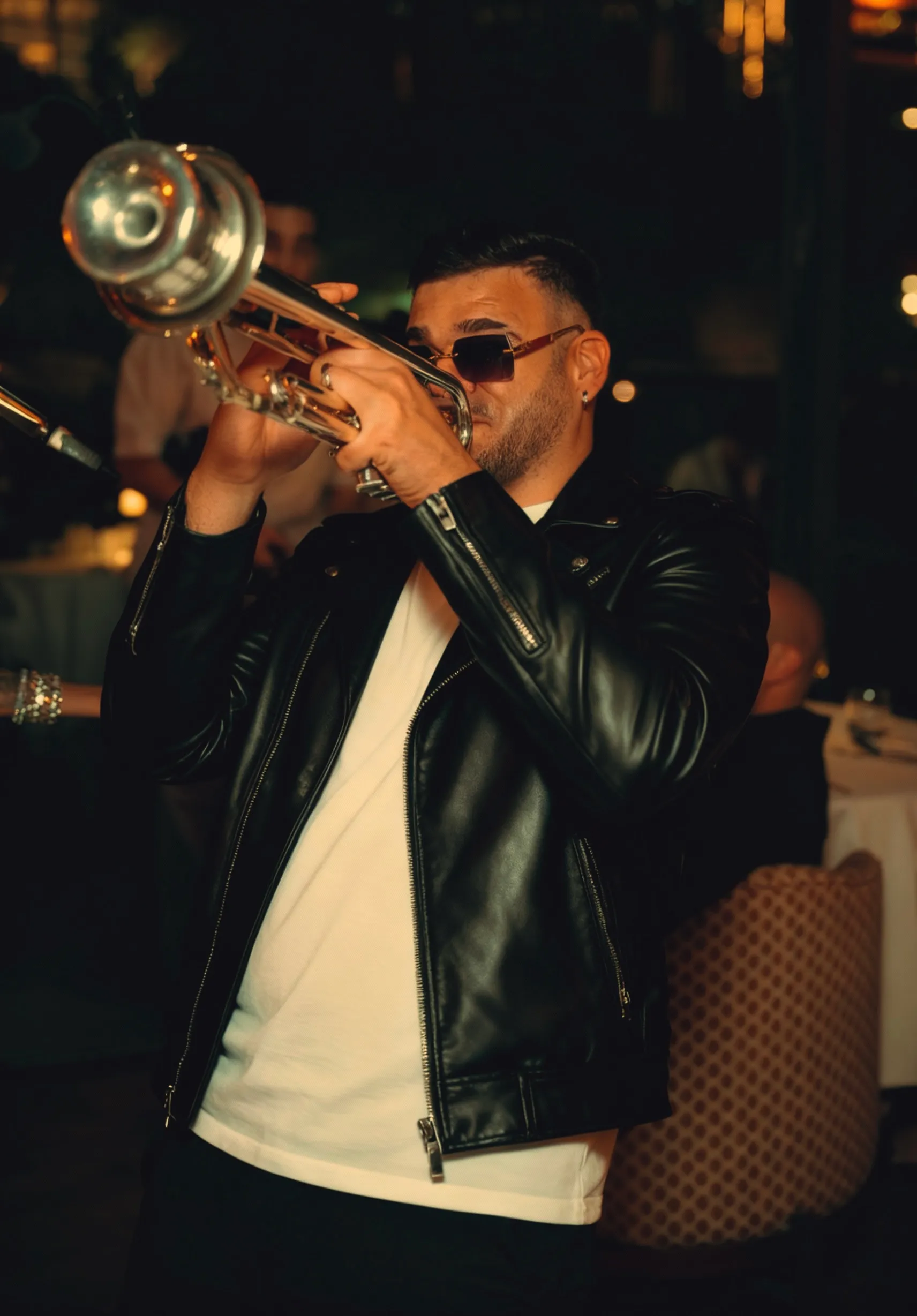 Darien Polo playing trumpet live at a night venue